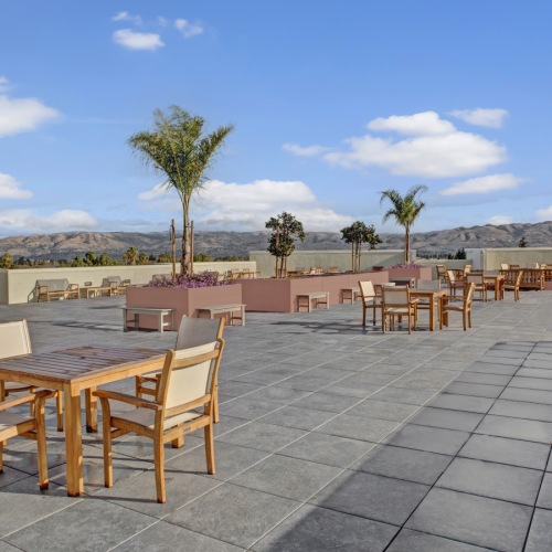 Rooftop Terrace Affordable Apartments for Rent in San Jose CA - Virginia Street Studios - A Spacious Rooftop Deck With Many Tables And Chairs As Well As Benches That Provide You With Beautiful 360 Views Of The Skyline
