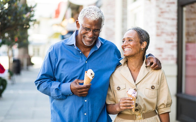 Older couple walking on the street with ice cream